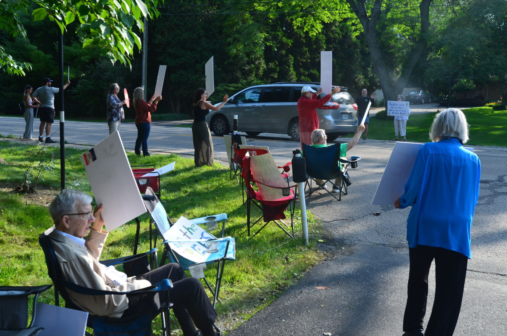 Protestors hold signs